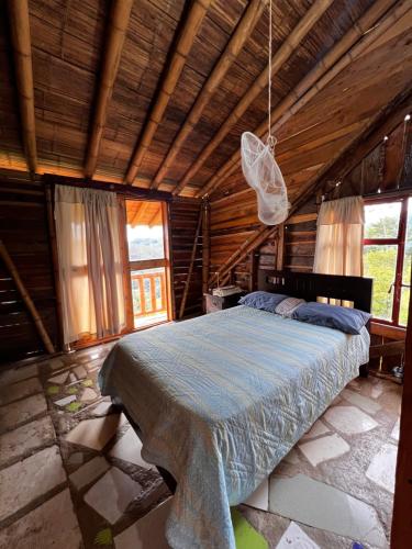 a bedroom with a bed in a wooden house at Rustic Cabin in Salento in Salento