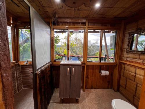 a bathroom with a sink and some windows at Rustic Cabin in Salento in Salento