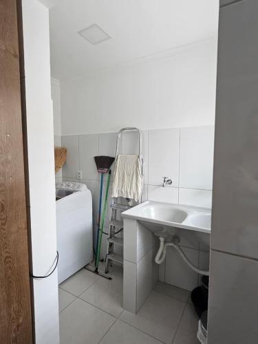 a white bathroom with a sink and a tub at Zanotti's House in Santa Teresa