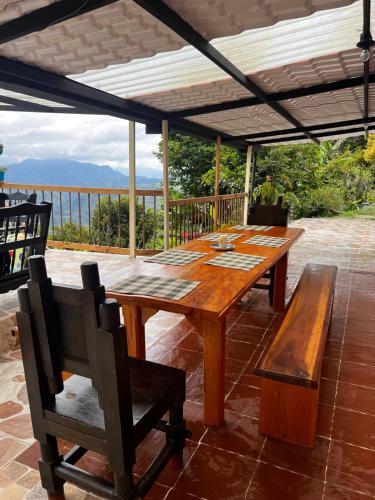 a wooden table and chairs on a patio at La TOLVA Café & experiencia in Pijao