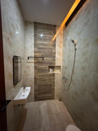 a bathroom with a sink and a shower at Omah Tentrem Magelang in Magelang