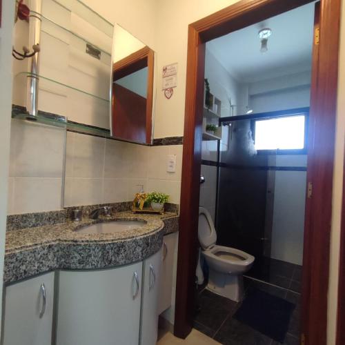 a bathroom with a sink and a toilet at Recanto Piemont in Serra Negra