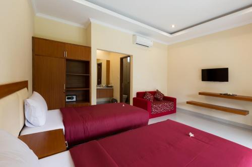 A television and/or entertainment centre at Kubu Petitenget Suite