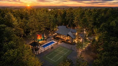 an overhead view of a house with a tennis court at Creek,Pool,Playhouse celebration estate, sleeps 21 in Broken Bow