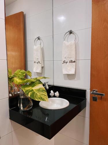 a bathroom with a sink and a mirror at Prédio Solar do Atlântico, apt 204 - Apartamento lateral em Tambaú in João Pessoa