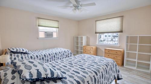 a bedroom with two beds and a ceiling fan at Illinois Avenue Hideaway in Cape May