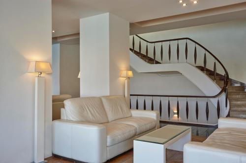 a living room with a couch and a staircase at Lucy Hotel in Chalkida