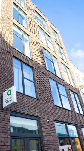 a brick building with a sign on the side of it at Aptel East in London
