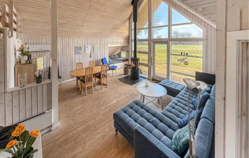 a living room with a blue couch and a table at Holiday Home Asperup 55 in Asperup
