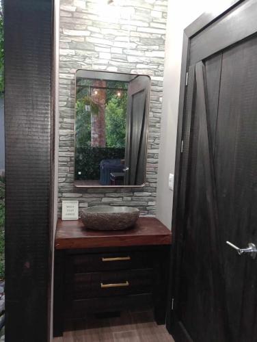 a bathroom with a sink and a mirror at Tropical Escape Domes in Guápiles