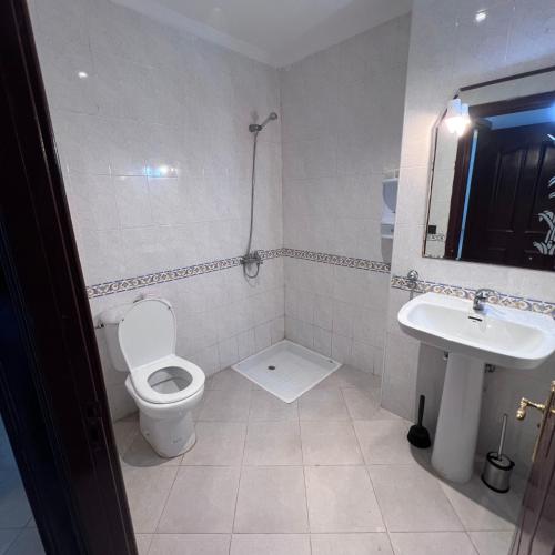 a bathroom with a toilet and a sink at Apparemment marina smir in Marina Smir