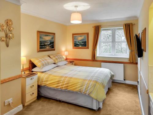 a bedroom with a bed and a window at Brompton Lodge in Ganton