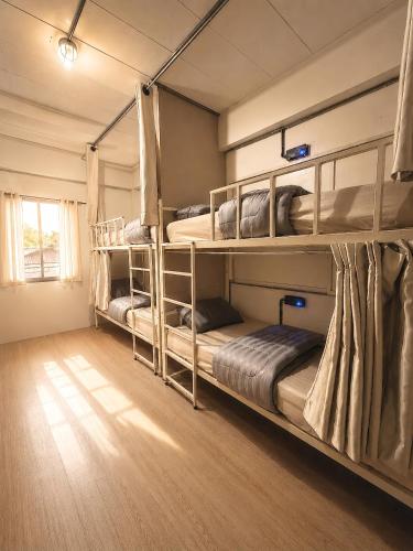 a room with three bunk beds in a room at Youyen Hostel in Ban Don Muang (1)