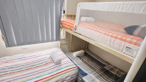 a small room with a bunk bed and a small bedskirts at At Busso Cabin 56 in Broadwater