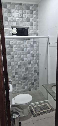 a bathroom with a toilet and a shower at Studio Central in Campo Grande
