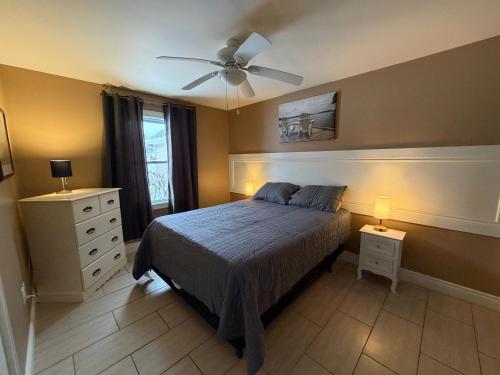 a bedroom with a bed and a ceiling fan at Home Away From Home in Stanley Bridge