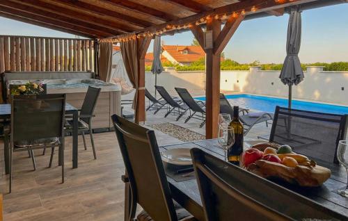 a patio with a table and chairs and a swimming pool at Stunning Home In Kutina With Sauna in Kutina