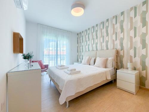 a bedroom with a large white bed in a room at Chromata Penthouse Apartment in Paralimni