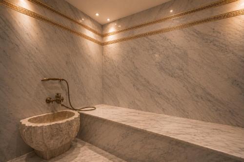 a bathroom with a large stone sink in a tub at Kasbel 2 Appart & Pool in Marrakesh