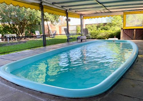 a large swimming pool with a gazebo at El Cantaro in Villa Elisa