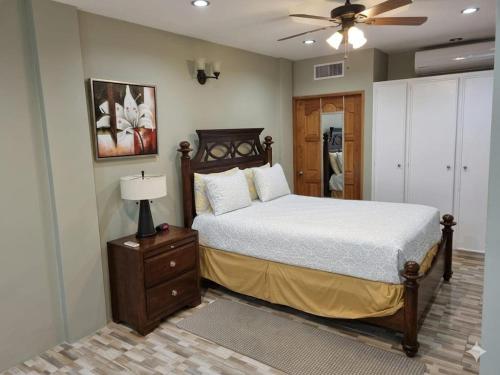 a bedroom with a bed and a ceiling fan at Paradise Place Apartments in Mount Irvine