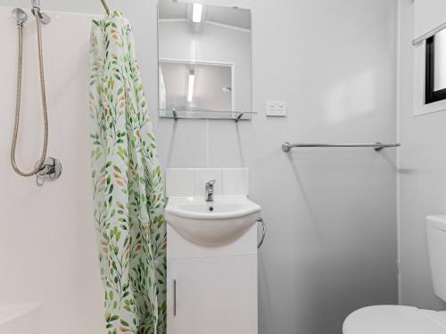 a white bathroom with a sink and a toilet at BIG4 Casino Holiday Park in Casino