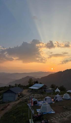 a group of tents on a hill at sunset at Nongkhiaw Camping 360 c top mountain view in Nongkhiaw