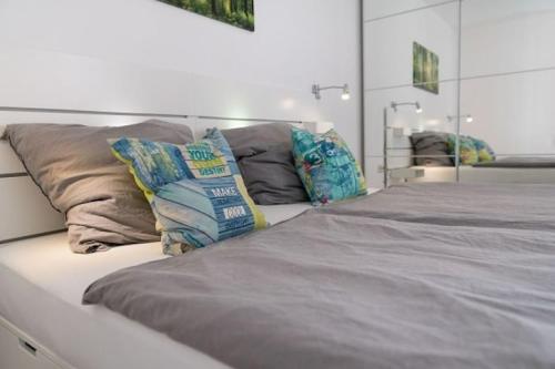 a large bed with two pillows on top of it at Ferienwohnung auf Fehmarn in Orther Reede in Orth