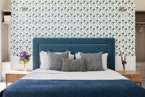 a bedroom with a blue bed with a blue head board at The Jetty, Port Willunga in Port Willunga