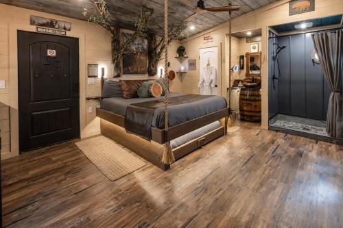 a bedroom with a large bed and a bathroom at "Morning Wood" Luxury Treehouse Retreat Near Dollywood & Pigeon Forge in Sevierville