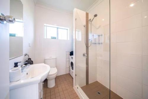 a bathroom with a toilet and a sink and a shower at Clouds on Francis - Cosy Comfort off Melbourne St in Bowden