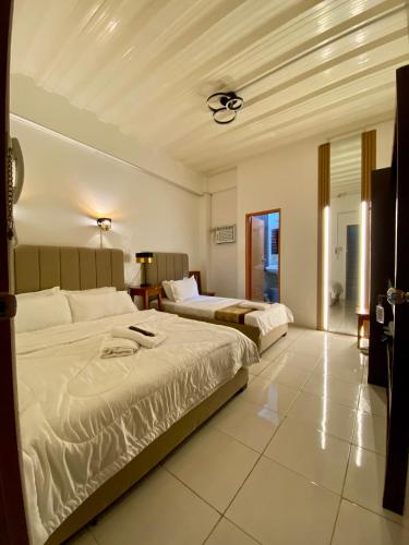 a hotel room with two beds in a room at The P Residences in San Agustin