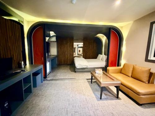 a room with a bed and a couch and a table at 로미오앤줄리엣 in Daegu
