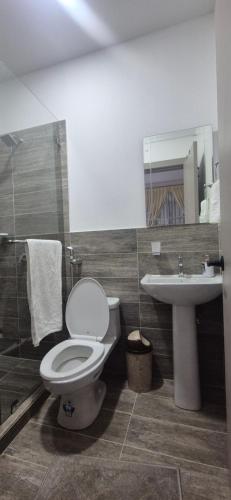 a bathroom with a toilet and a sink at Renata's Depar in Punta Blanca