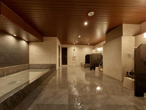 a large room with a bathroom with a sink at Hotel Resh Tottori Ekimae in Tottori