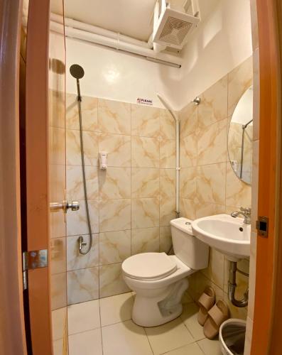a bathroom with a toilet and a sink at The P Residences in San Agustin