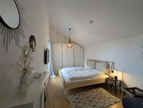 a bedroom with a bed in a white room at Heilige-Hafen-Lodge in Heiligenhafen