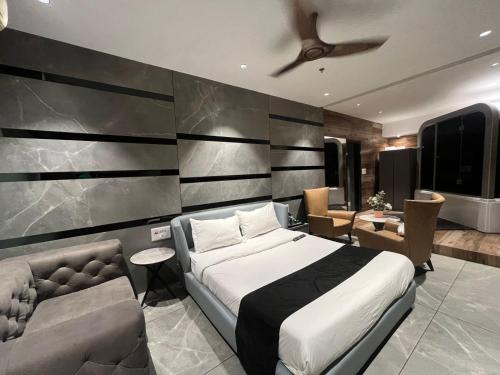a bedroom with a bed and a couch at Hotel Welcome Palace in Surat