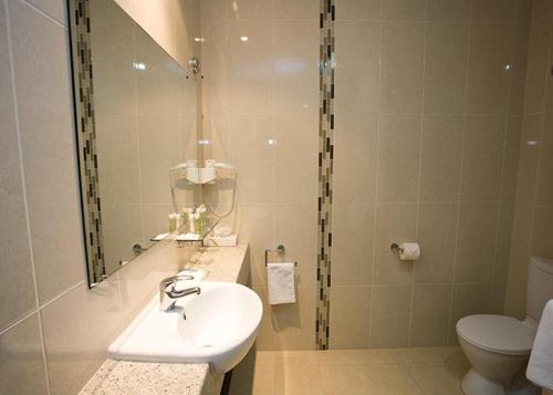a bathroom with a sink and a toilet at Hibernian Hotel in Beechworth