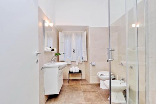 a bathroom with a toilet and a sink and a shower at RomeAsYouLike-Monti Experience 295 in Rome