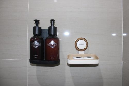 two bottles of soap sitting on a counter next to a mirror at San Franz Hotel La Perla in San Francisco