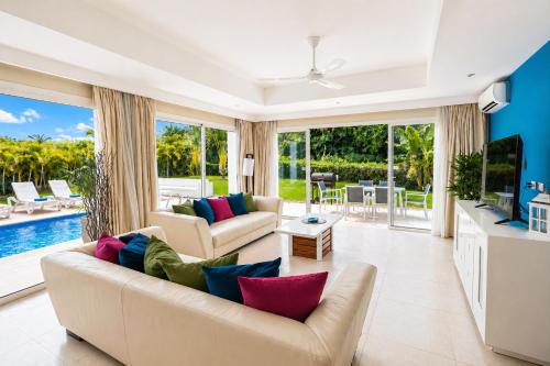 a living room with a couch and a tv at Special offer! Villa Bueno with private pool&beach in Punta Cana