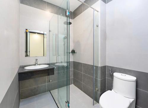 a bathroom with a toilet and a glass shower at Hotel Duy Phương 2 in Da Lat