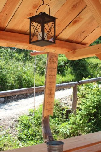 a light hanging from the ceiling of a wooden roof at Eirl DOLOMITES Retreat Sappada in Sappada