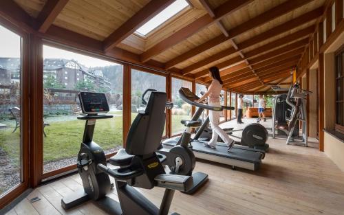 a woman exercising on tread machines in a gym at Alpejski Boutique Hotel in Karpacz