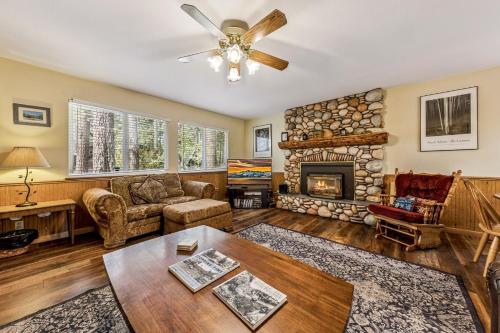 a living room with a fireplace and a ceiling fan at 838 Placer Avenue home in South Lake Tahoe