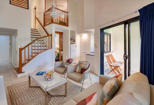 a living room with a couch and a table at Freestyle Resort Port Douglas in Port Douglas