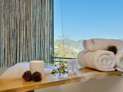 a room with a table with towels and pine cones at Stardome Apartment Dalat in Ấp Ða Lợi
