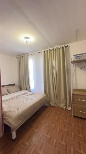 a small bedroom with a bed and a window at Mellow Place Staycation in Naic
