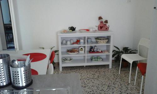 a room with a white shelf with dishes on it at Appartamento Piazza Buzi in Orvieto